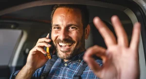 A tradesperson smiling while talking on the phone, representing the convenience of meeting room hire for tradespeople.